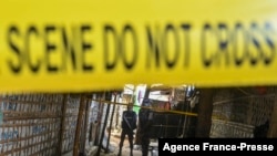 FILE - Police stand guard in October 2021 near the office of top community Rohingya leader and activist Mohib Ullah, who was killed by gunmen in late September, at Kutupalong refugee camp in Ukhia. 