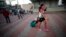 A Cuban migrant walks to a government organized bus that will take her and other Cuban migrants to the airport in La Cruz, Costa Rica, Tuesday, Jan. 12, 2016.