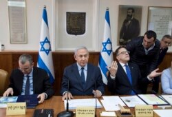 Israeli Prime Minister Benjamin Netanyahu, center, Cabinet Secretary Tzachi Braverman, right, and Tourism Minister Yariv Levin attend the weekly cabinet meeting at the prime minister's office, in Jerusalem, Jan. 27, 2019.