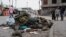 People look at military uniforms and equipment abandoned in the streets of Goma amid conflict between M23 rebels and the Congolese army in Goma, Democratic Republic of the Congo, on Jan. 29, 2025.