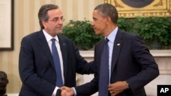 President Barack Obama shakes hands with Greek Prime Minister Antonis Samaras during their meeting in the Oval Office of the White House in Washington, Aug. 8, 2013. 