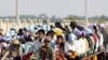 Cambodian garment factory workers travel together in motor carts to get home from work at the Sala Lek Pram village, Kampong Chhnang province.