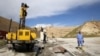 FILE - Employees work at strengthening the Mosul Dam in northern Iraq, April 18, 2016. 