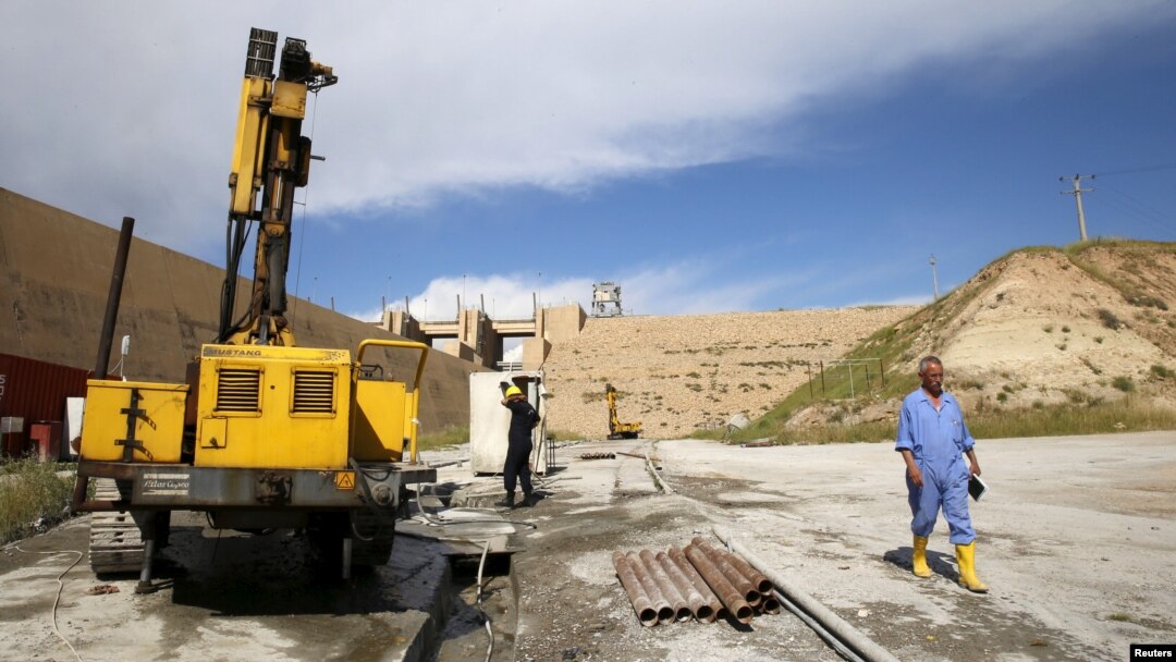 FILE - Employees work at strengthening the Mosul Dam in northern Iraq, April 18, 2016. 