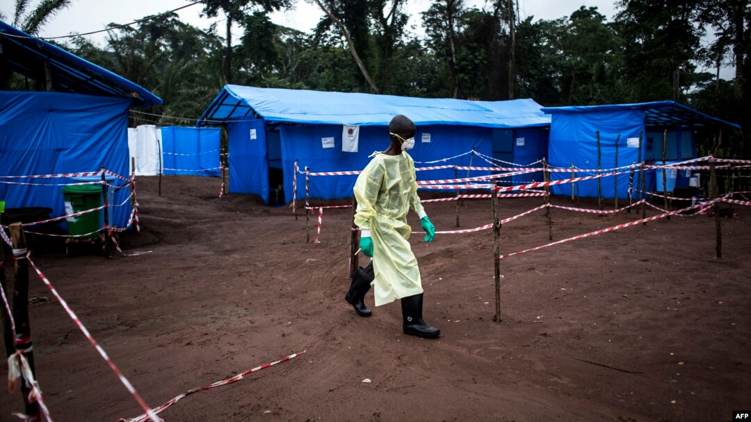 FILE - A health worker walks at an Ebola quarantine unit, June 13, 2017 in Muma, DRC, after a case of Ebola was confirmed in the village.