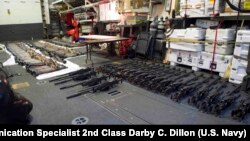 A cache of weapons is assembled on the deck of the guided-missile destroyer USS Gravely (DDG 107). The weapons were seized from a stateless dhow which was intercepted by the Coastal Patrol ship USS Sirocco on March 28. 