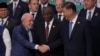 Brazil's President Luiz Inacio Lula da Silva, left, shakes hands with China's President Xi Jinping as they gather for a G20 Summit world leaders' group photo, in Rio de Janeiro, Nov. 19, 2024.