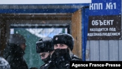 Russian police officers patrol near Listvyazhnaya coal mine in the Kemerovo region near the town of Belovo after an accident Nov. 25, 2021.