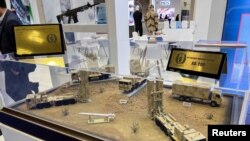 آرم سپاه در کنار مدل‌های پدافند ضد-هوایی در نمایشگاه دوحه نمایان است