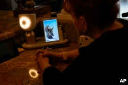 Deanna Dezern, 83, interacts with her ElliQ, a tabletop device that uses artificial intelligence to conduct human-like conversations, inside her home in Tamarac, Florida, on December 7, 2023. (AP Photo/Rebecca Blackwell)