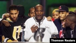 File - Rapper DMX offers a prayer after winning the R&B Albums Artist of the Year award.