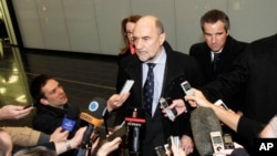 Herman Nackaerts (C), Deputy Director General and Head of the Department of Safeguards of the International Atomic Energy Agency, talks to media after his arrival from Iran at Vienna's Schwechat airport, Austria, February 14, 2013.