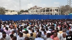 Thousands of Somalis gather to pray at the site of the country's deadliest attack and to mourn the hundreds of victims, at the site of the attack in Mogadishu, Somalia, Oct. 20, 2017.