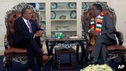 FILE - United States Ambassador to Zimbabwe Brian Nichols, left, is seen during a courtesy call with Zimbabwean President elect Emmerson Mnangagwa at his official residence State House in Harare, Aug, 15, 2018. Nichols emphasized the need to respect human rights.