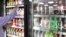 FILE - A shop owner reaches into a drink display refrigerator at his convenience store in Kent, Washington, Oct. 1, 2018. A study on America’s eating habits released on Tuesday, Sept. 24, 2019 shows only slight improvement from 1999 to 2016.