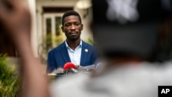 FILE - Leading opposition candidate in Uganda's presidential election Bobi Wine speaks to the press outside Kampala, Uganda, Jan. 15, 2021, one day after Ugandans went to the polls.