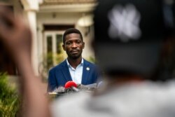 FILE - Leading opposition candidate in Uganda's presidential election Bobi Wine speaks to the press outside Kampala, Uganda, Jan. 15, 2021, one day after Ugandans went to the polls.