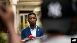 FILE - Leading opposition candidate in Uganda's presidential election Bobi Wine speaks to the press outside Kampala, Uganda, Jan. 15, 2021, one day after Ugandans went to the polls.