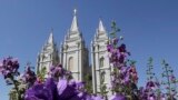 FILE - Flowers bloom in front of the Salt Lake Temple. in Temple Square, in Salt Lake City, Sept. 3, 2014.