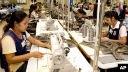 FILE: Cambodian garment workers sew clothes in a factory in Phnom Penh, Cambodia, Aug. 4, 2007. 