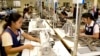 FILE PHOTO - Cambodian garment workers sew clothes in a factory in Phnom Penh, Cambodia, Aug. 4, 2007. (AP Photo/Heng Sinith)