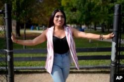 Julieth Luna Garcia, a transgender woman from El Salvador, poses for photos at Horner Park in Chicago on Sept. 30, 2024.