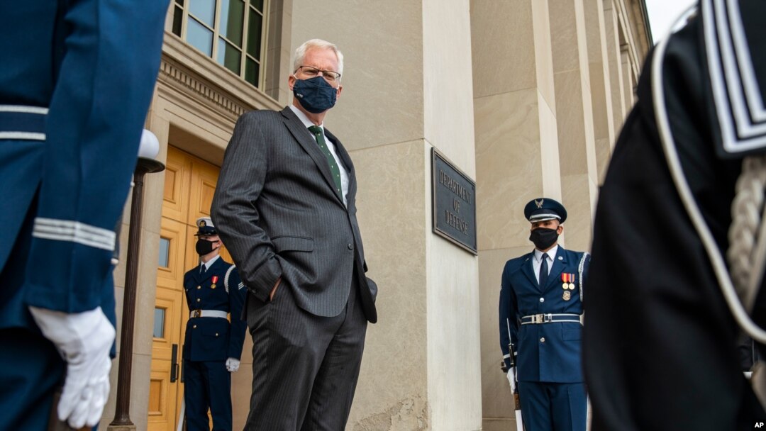 FILE - Acting U.S. Secretary of Defense Christopher Miller stands on the steps of the Pentagon entrance in Arlington, Virginia, Nov. 13, 2020. 