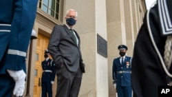 FILE - Acting U.S. Secretary of Defense Christopher Miller stands on the steps of the Pentagon entrance in Arlington, Virginia, Nov. 13, 2020. 