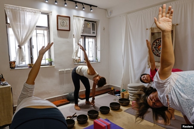 FILE - Young Hong Kongers wear workout clothes during a meditation session on September 2022. (REUTERS/Tyrone Siu)