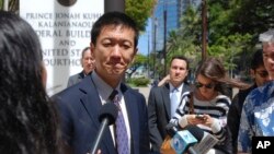 FILE - Hawaii Attorney General Douglas Chin speaks outside federal court in Honolulu, March 29, 2017. 