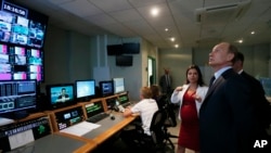 Russian President Vladimir Putin visits the headquarters of what was then known as the Russia Today television channel in Moscow, June 11, 2013 (Yuri Kochetkov/Pool Photo via AP, File)