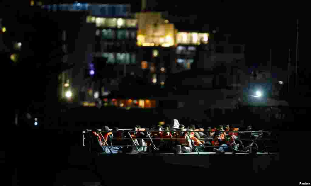 Migrants rescued by the Italian coastguard arrive on an Armed Forces of Malta patrol boat in Valletta's Marsamxett Harbor, Malta, Sept. 17, 2019.