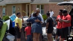 President Barack Obama greets residents as he tours Castle Place, a flood-damaged area of Baton Rouge, Louisiana, Tuesday, Aug. 23, 2016. (AP Photo/Susan Walsh)