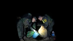 Tim anti-narkoba kepolisian Kolombia memeriksa zat kimia yang digunakan dalam produksi koka di sebuah laboratorium di kawasan terpencil di Orito, Putumayo, Kolombia, pada 9 April 2022. (Foto: AP/Fernando Vergara)