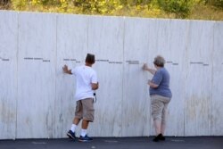 Visitors to the Flight 93 National Memorial in Shanksville, Pa., view the Wall of Names, Sept. 10, 2019, as the nation prepares to mark the 18th anniversary of the Sept. 11, 2001 attacks.