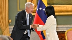 US Energy Secretary Chris Wright (L) and Venezuela's interim President Delcy Rodriguez (R) shake hands during the signing of an oil agreement at the Miraflores Presidential Palace in Caracas on September 2, 2026.