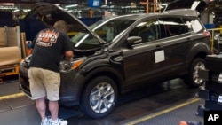 FILE - Louisville Assembly Plant workers build the redesigned 2013 Escape, June 13, 2012 in Louisville, Ky. Ford has transformed the nearly 60-year-old assembly plant into the new home of the redesigned Escape. And it's bolstered the workforce to make the vehicle.