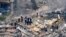 Rescue workers search in the rubble at the Champlain Towers South Condo, in Surfside, Fla., June 25, 2021.