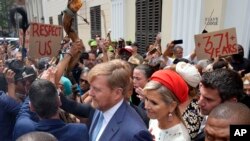 Khoisan protesters surround King Willem Alexander and Queen Maxima of the Netherlands at the Iziko Slave Lodge museum in Cape Town during their state visit to South Africa Friday, Oct. 20, 2023. 