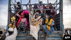 FILE—Sudanese refugees who have fled from the war in Sudan get off a truck loaded with families arriving at a Transit Centre for refugees in Renk, on February 13, 2024.