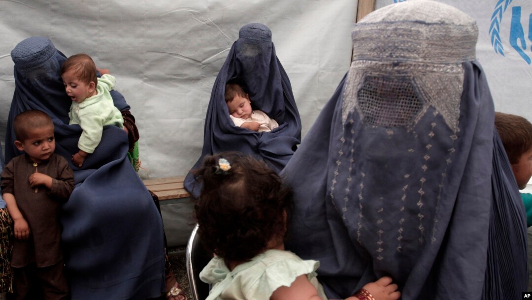 Returning Afghan refugees, who have recently arrived from Pakistan, wait during the registration process at a United Nations High Commissioner for Refugees center on the outskirts of Kabul, Afghanistan, June 20, 2013.