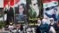 Ahead of Tuesday's election, women walk past election posters of Syria's President Bashar al-Assad along a street in Damascus, Syria, June 2, 2014. 
