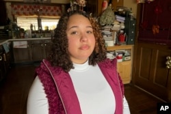 Mia Woodard sits in her grandmother's kitchen on Wednesday, Feb. 1, 2023 in Jackson, Tenn. Woodard is among hundreds of thousands of Americans who came of age during the pandemic but didn't go to college. (AP Photo/Patrick Orsagos)