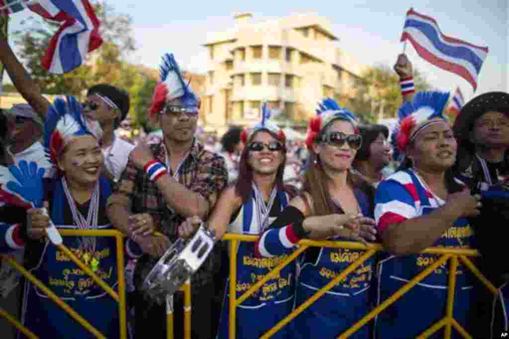 Thai anti-government protesters, dressed up in national flags, stand during a rally at the Democracy Monument in Bangkok, Sunday, Jan. 12, 2014. Anti-government demonstrators were preparing Sunday to occupy major intersections of Thailand's congested capi