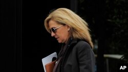 FILE - Spain's Princess Cristina walks toward her office in Barcelona, Spain.