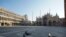 Pidgeons fly in deserted St. Mark's Square, in Venice, Monday, April 6, 2020.