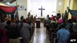 FILE - People worship at the Anglican Church of Redemption, Diocess of Lagos West, Ibafo in Ogun State, southwest Nigeria, Jan. 1, 2021. A report by a U.S-based monitoring group says Nigeria became the world's biggest killing spot for Christians in 2020.