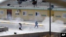 Libyan rebels continue to fight inside Moammar Gadhafi's compound Bab al-Aziziya in Tripoli, Libya, early Wednesday, August 24, 2011