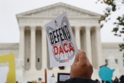 FILE - People rally outside the U.S. Supreme Court in Washington in support of the Deferred Action for Childhood Arrivals program, Nov. 12, 2019.