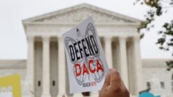 FILE - In this Nov. 12, 2019, photo, people rally outside the Supreme Court. The Trump administration must accept new applications for the DACA program that protects some young immigrants from deportation, a federal judge ruled Dec. 4, 2020.